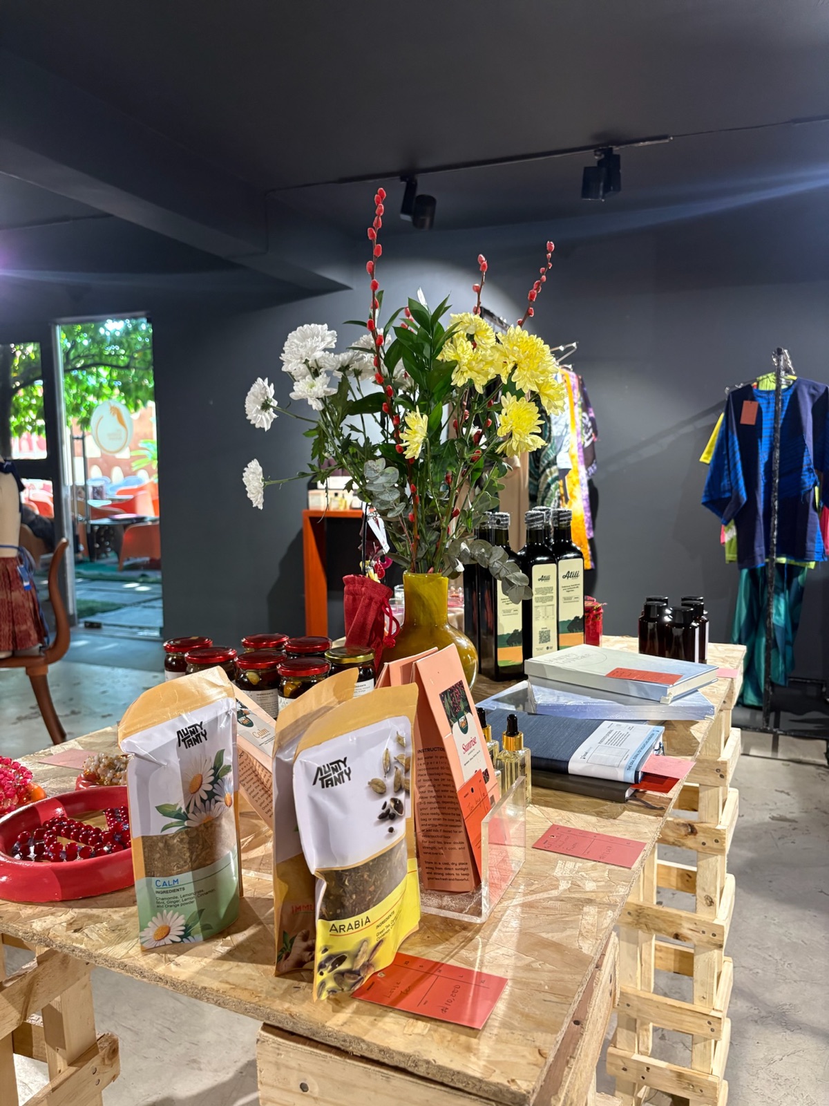 Vendor table with flowers, pantry goods and books at an EBBE pop-up