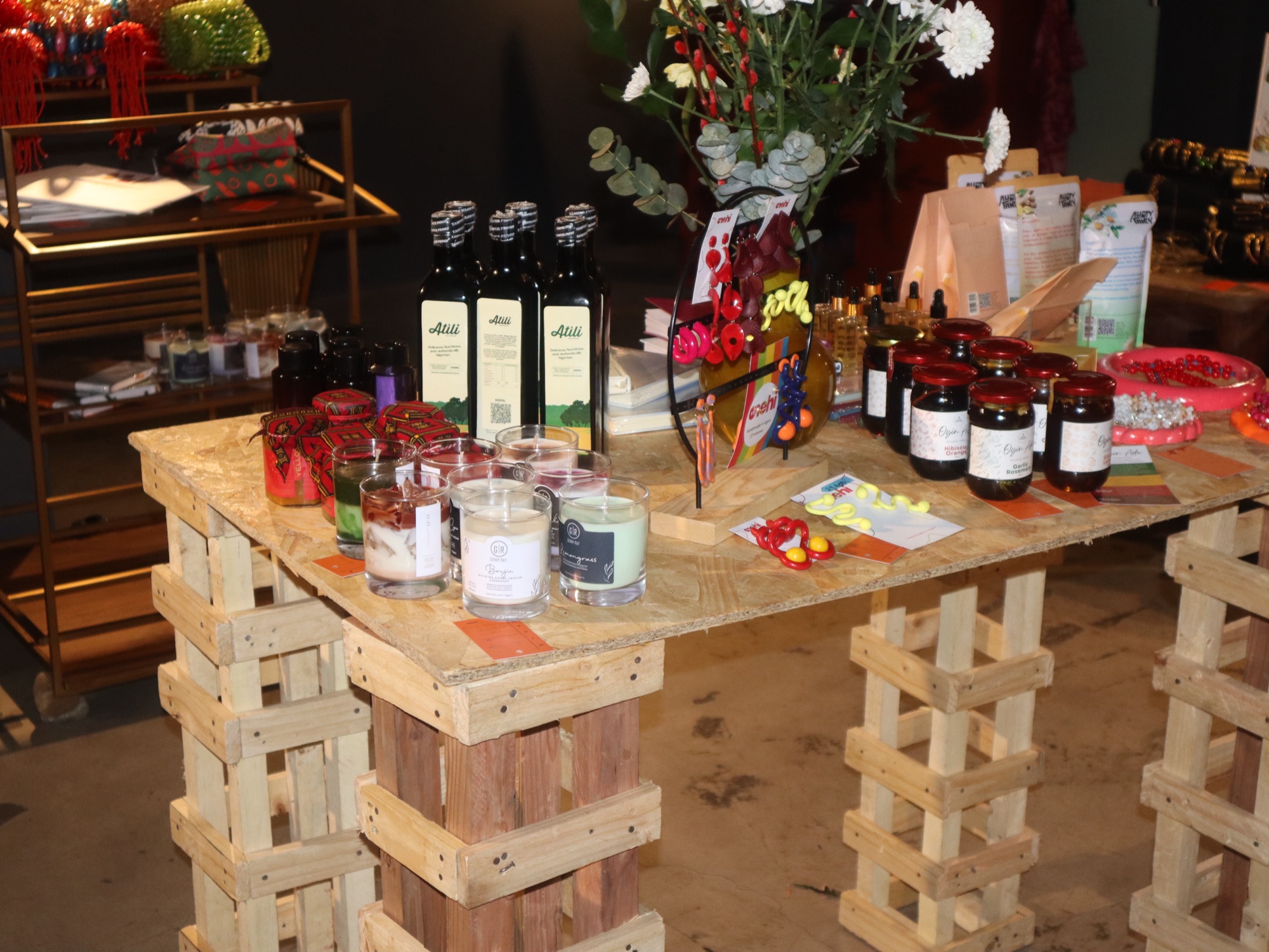 Styled vendor table with candles, oils and preserves