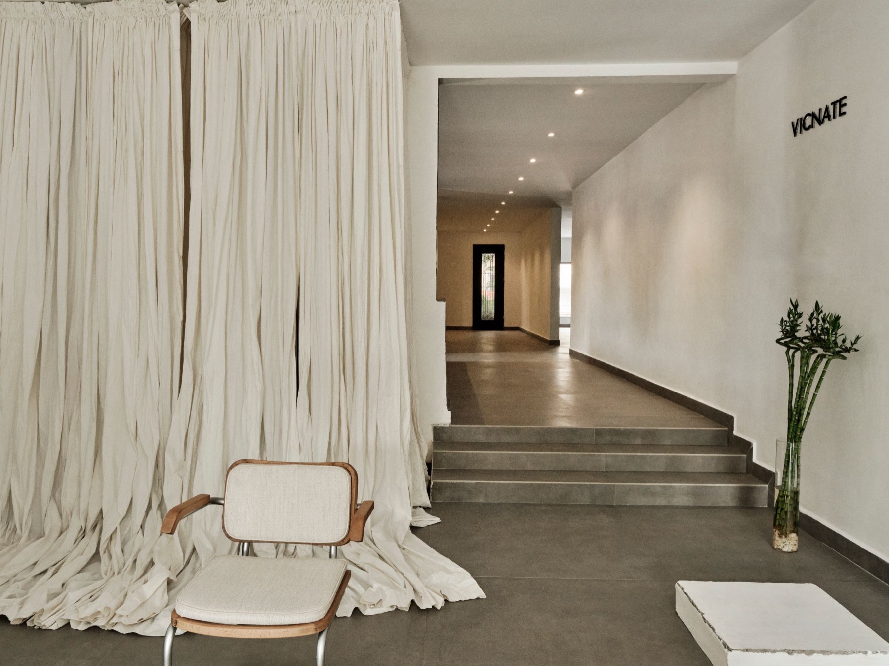 Entrance to the Vicnate × EBBE pop-up, with draped cream curtains and the Vicnate sign