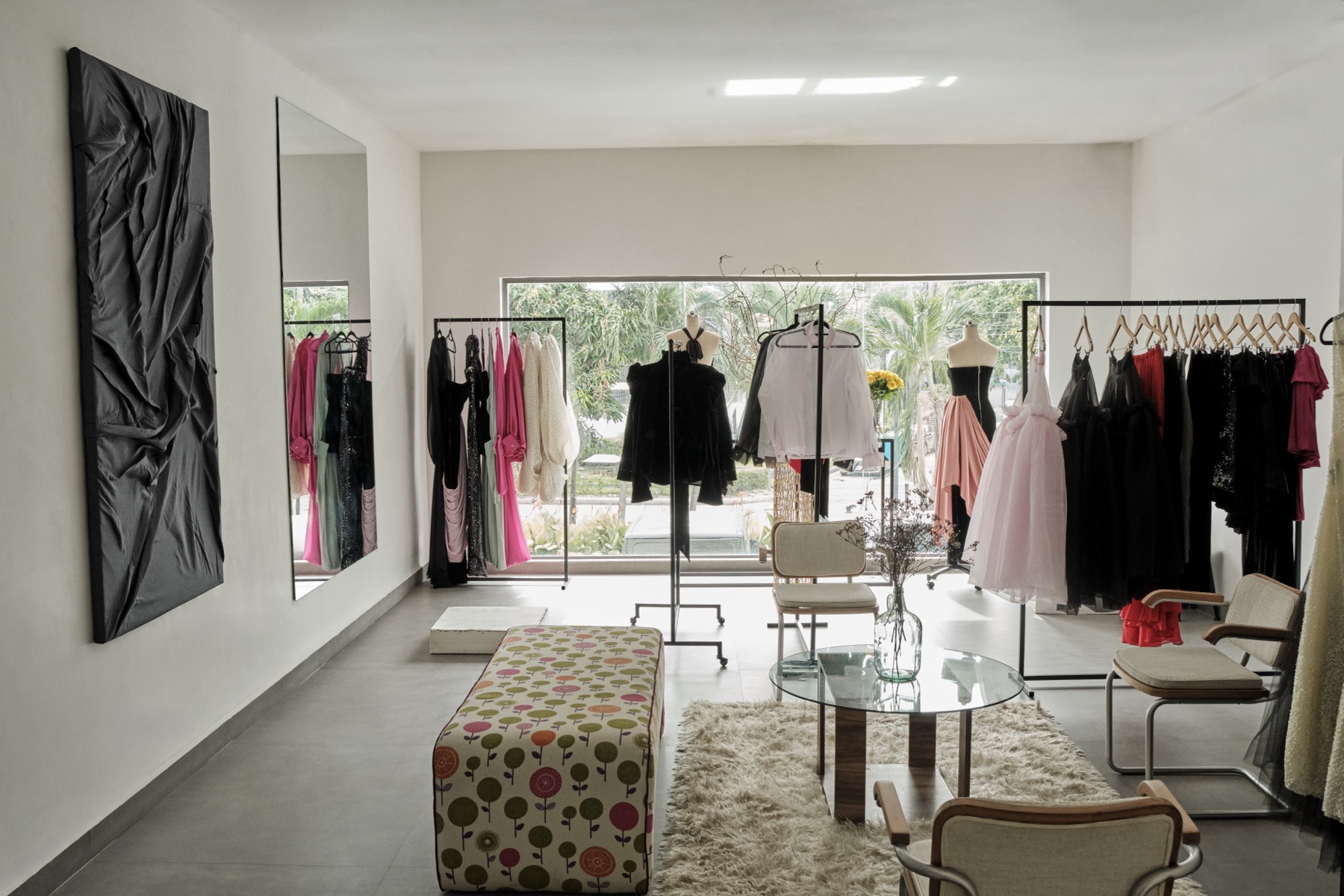 Vicnate showroom styled for the pop-up: rails of gowns, mannequins and a lounge corner