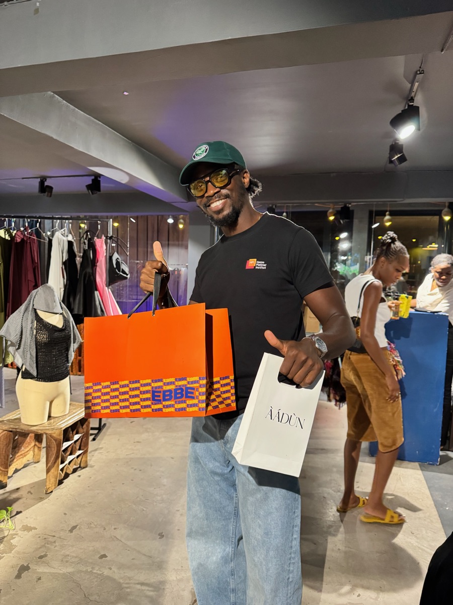 A guest holding two orange EBBE bags