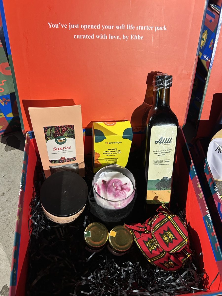 An open EBBE box: teas, a candle, oil and a printed pouch